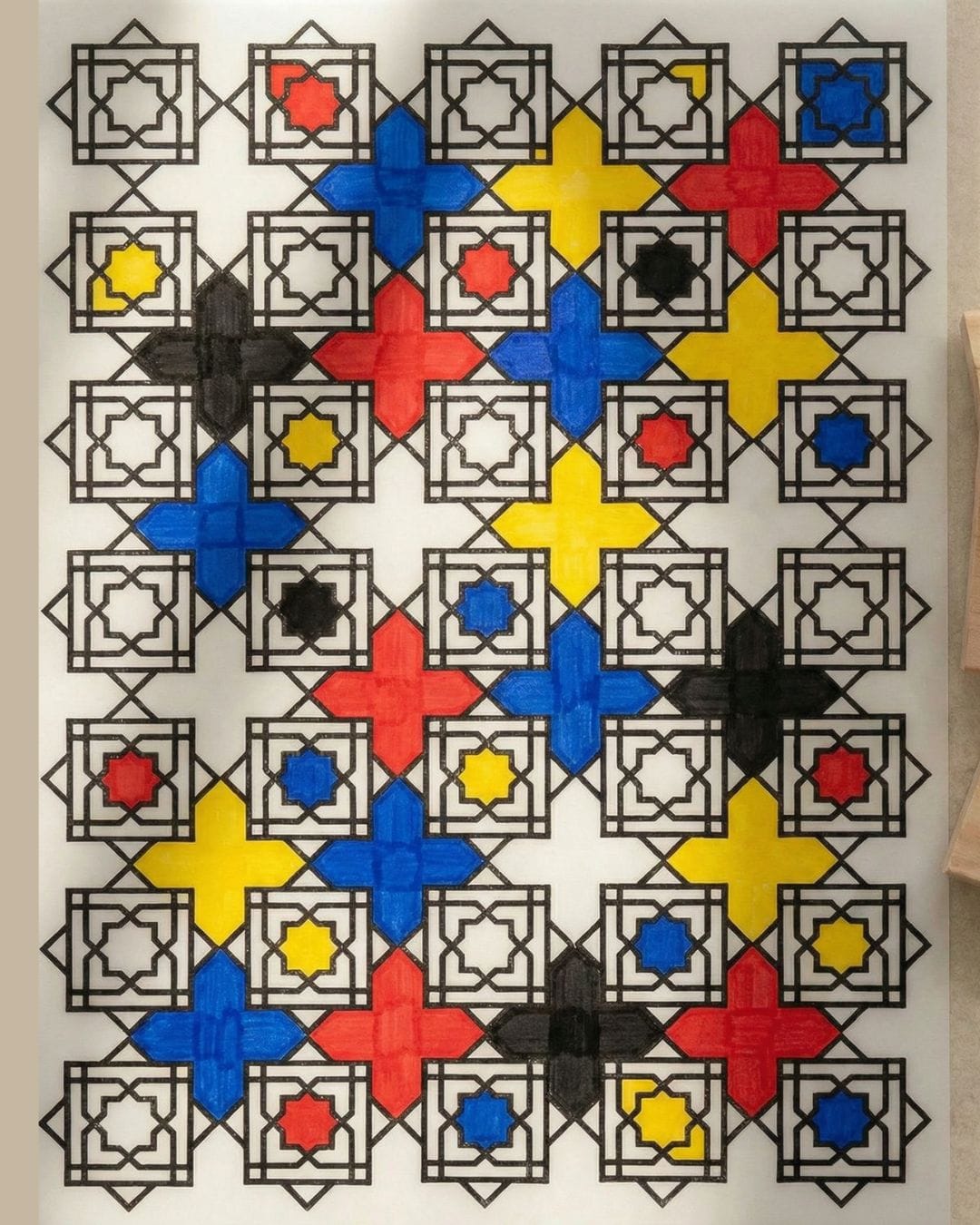 DIY Mondrian-inspired geometric wall art using Islamic pattern stamps, filled with red, blue, yellow and black acrylic colour on paper