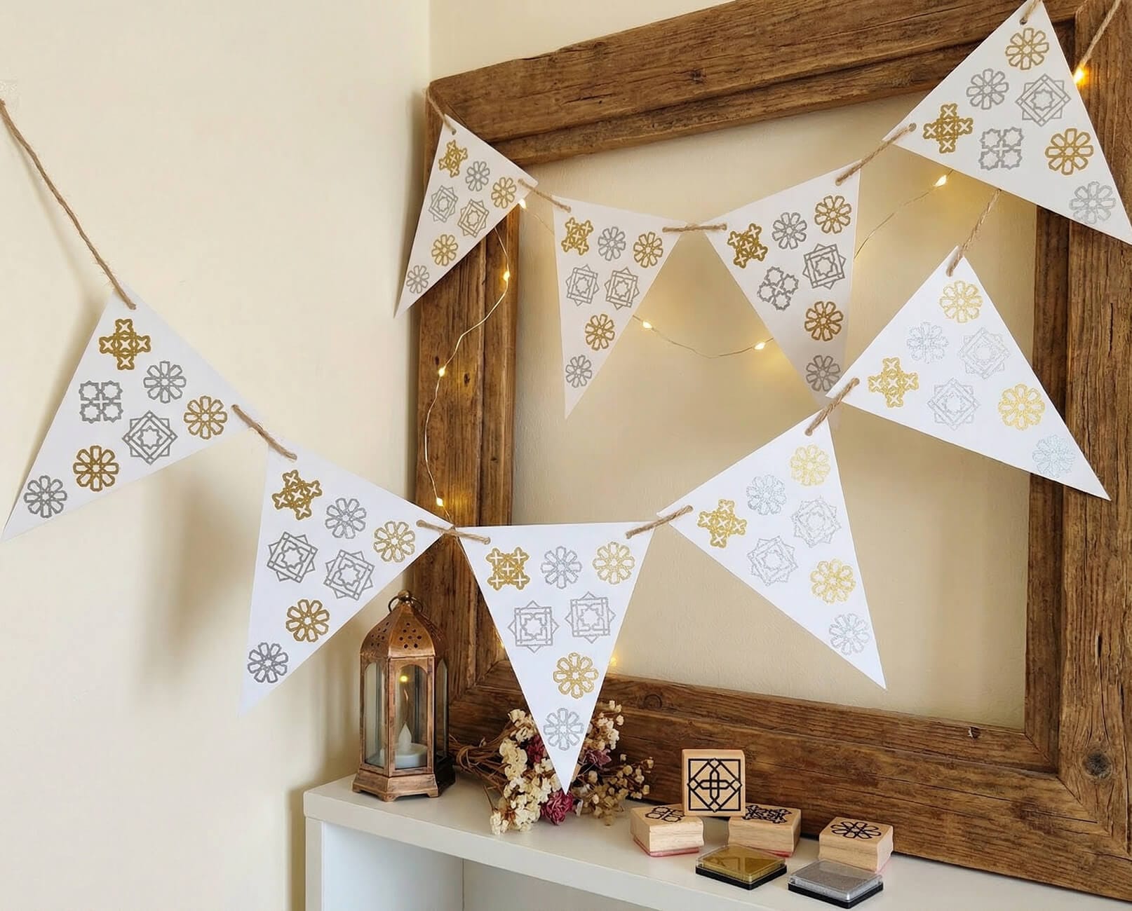 DIY Ramadan bunting made with Islamic geometry stamps, hanging in a home prayer corner as simple Ramadan decor.