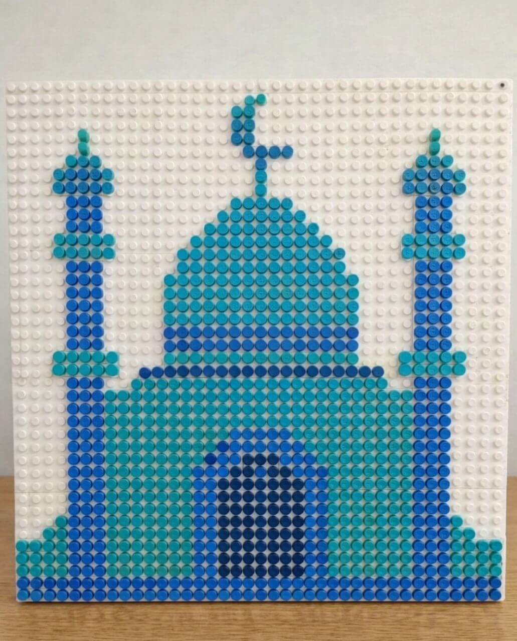 Mosque silhouette created with blue and turquoise LEGO dots on a white baseplate as an Islamic art activity for kids