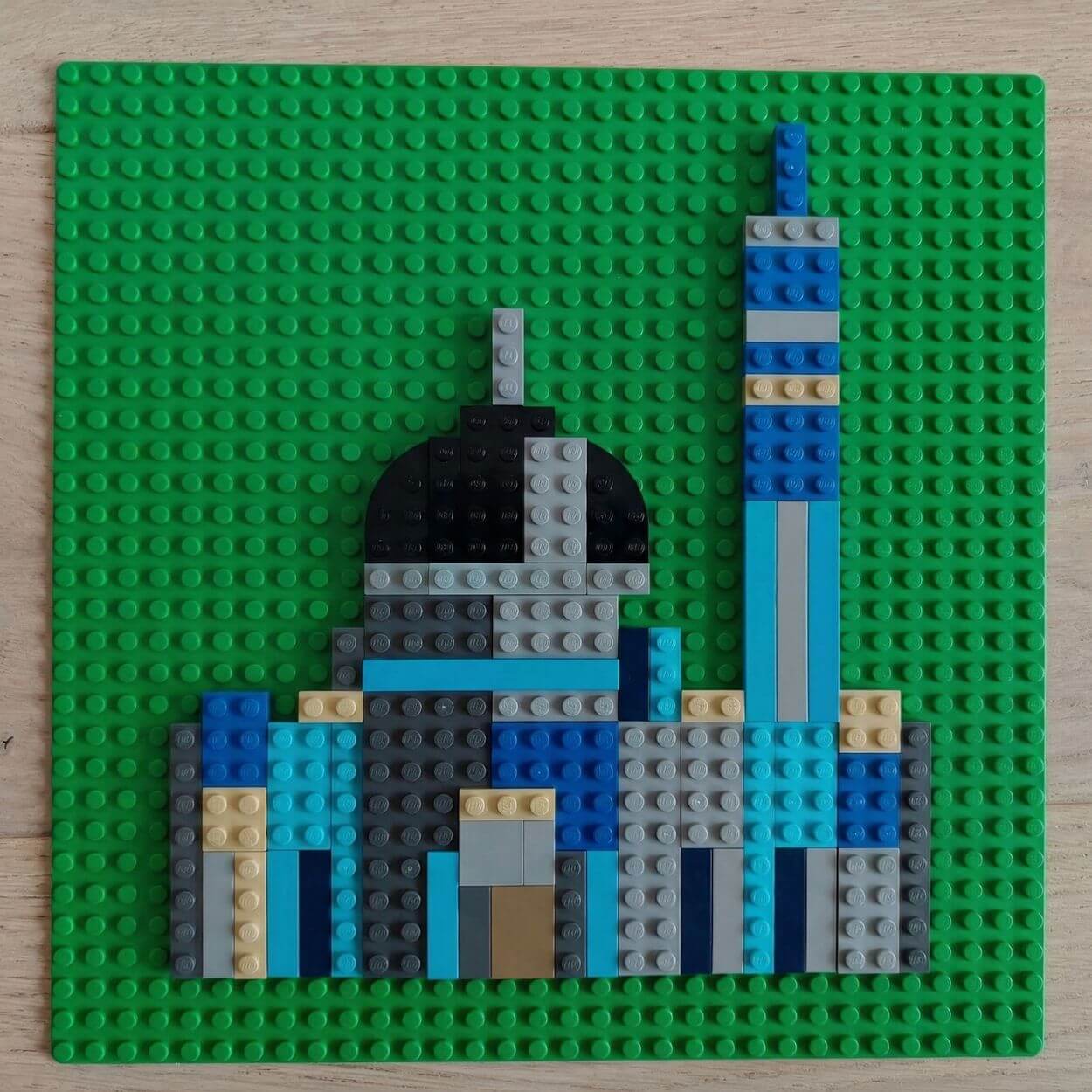 Simple mosque shape created with LEGO bricks on a green baseplate as a screen-free Islamic art activity for kids