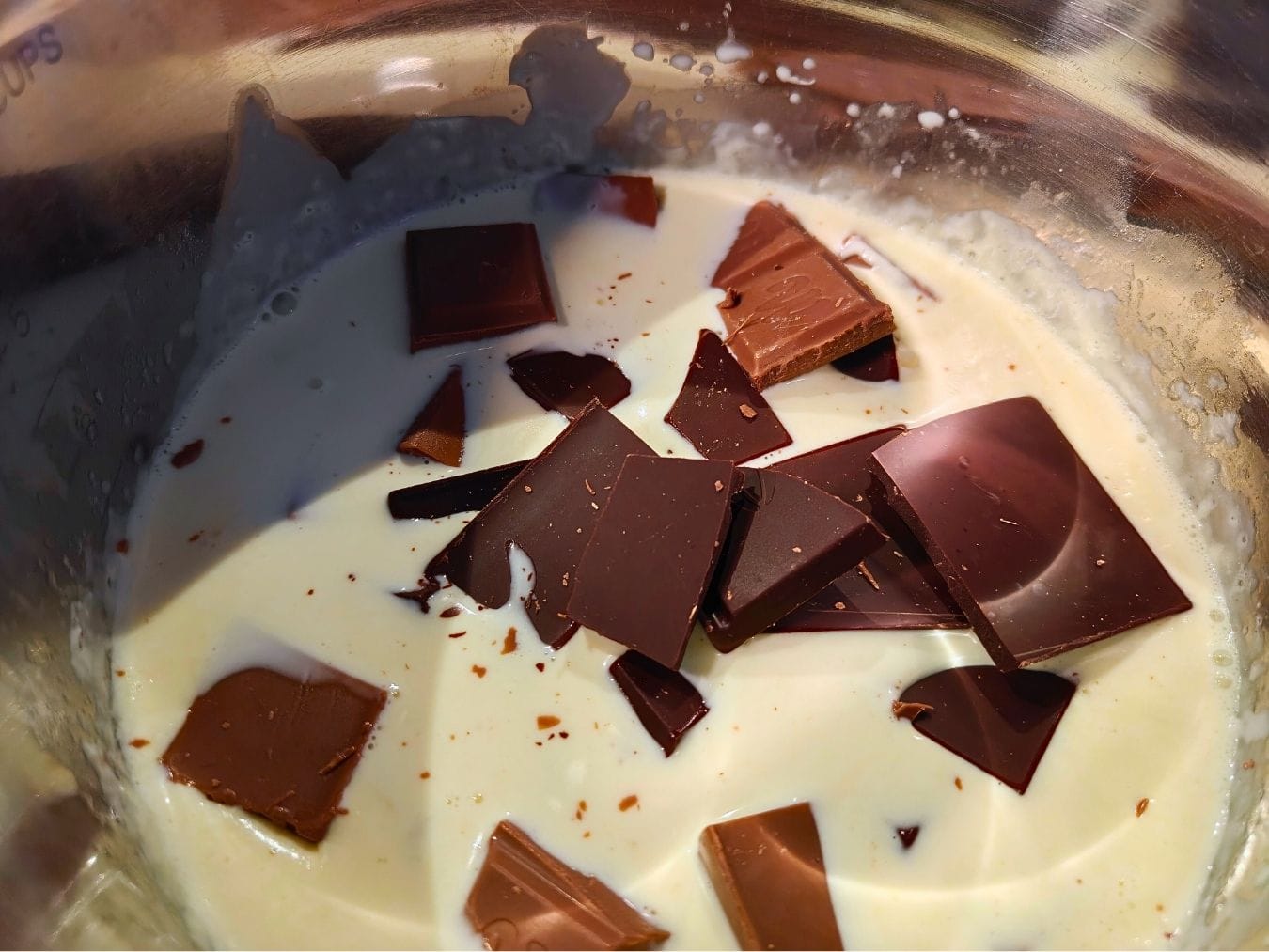 Chopped milk and dark chocolate added to warm cream to melt gently for chocolate kataifi salami