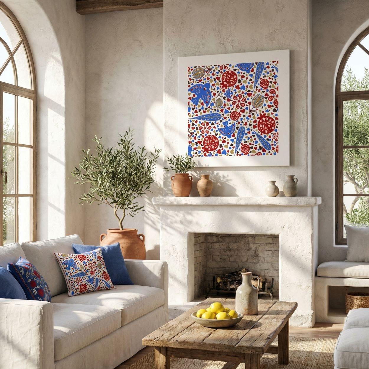 Persian pomegranate and bird wall art print displayed above a fireplace in a warm Mediterranean-style living room with neutral walls, olive tree, and natural wood furniture.
