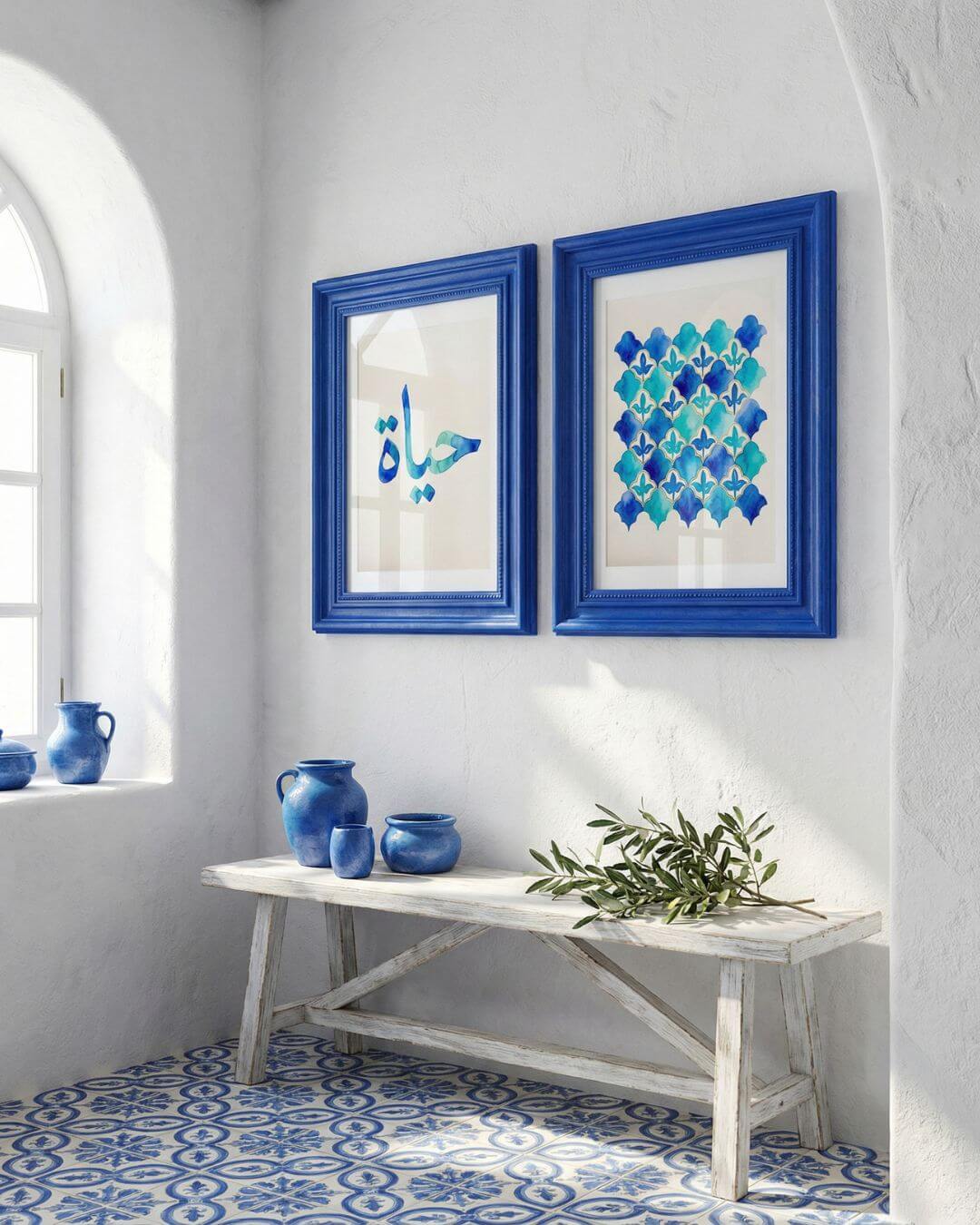 Blue-framed Hayat Arabic calligraphy print paired with a matching watercolor Islamic tile artwork in a bright Mediterranean-style interior