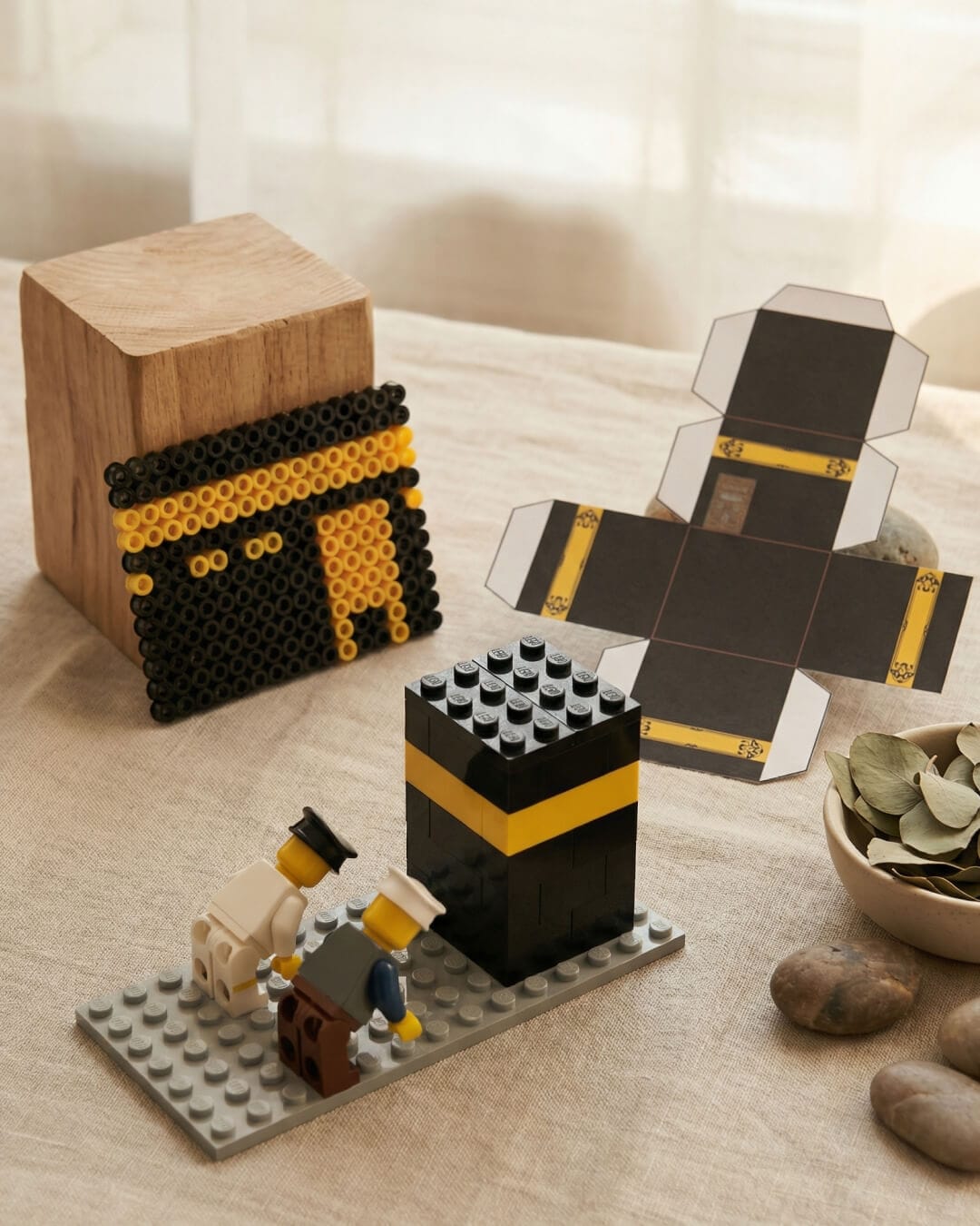 DIY Kaaba craft ideas for children including a LEGO Kaaba, Perler bead Kaaba design, and printable paper Kaaba model on a calm neutral background.