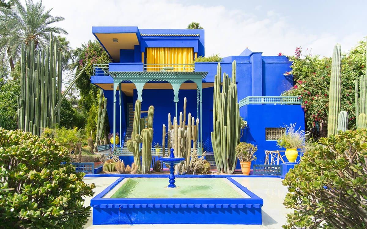 Bright blue Jardin Majorelle building with a central fountain, cactus garden, and geometric Moorish details in Marrakech