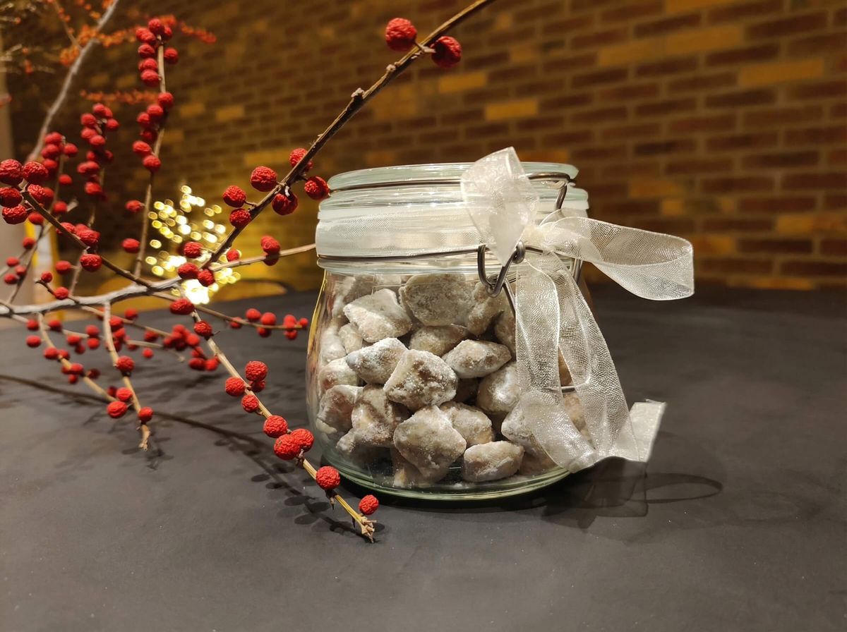 Jar of pistachio Puppy Chow, also known as Reindeer Chow, dusted with icing sugar