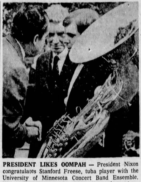 Photo of Nixon shaking hands with a tuba player.