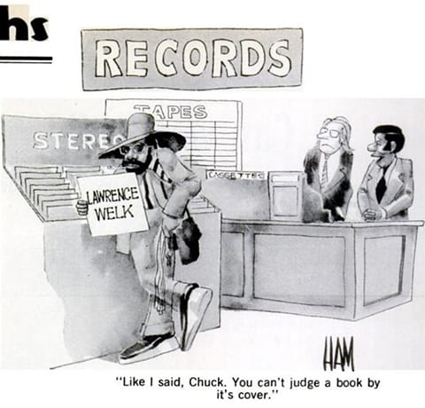A fashionable black man looks at a Lawrence Welk record in a record store. A black employee says to a white coworker, "Like I said, Chuck, you can't judge a book by its cover."