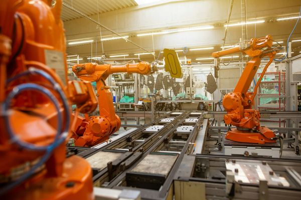 Robots assembling automotive products in a smart factory (Photo by Simon Kadula on Unsplash)