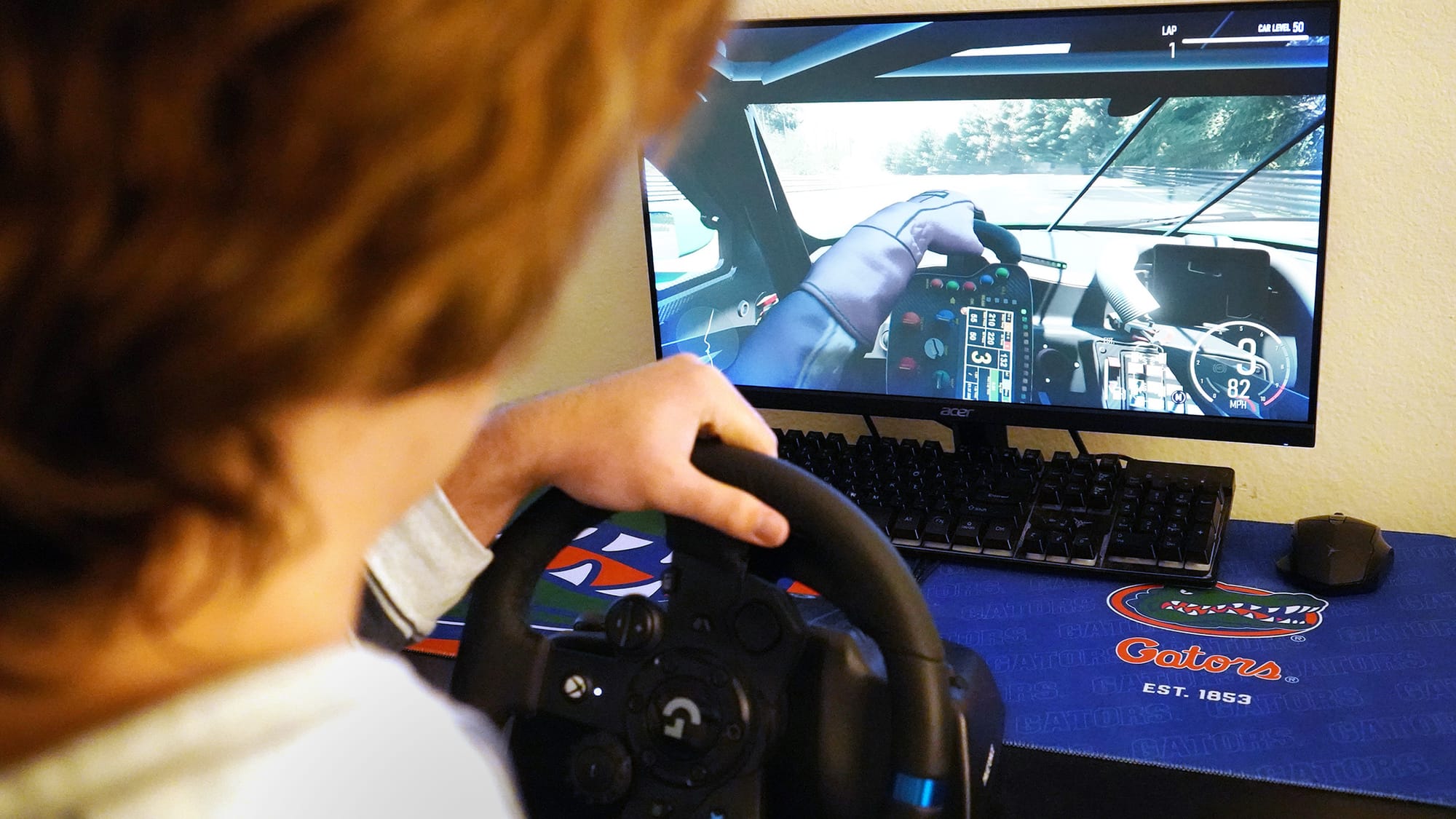 UF student Jack Dobias turns the steering wheel while playing Forza Motorsport in his Gainesville apartment on Nov. 12, 2025.