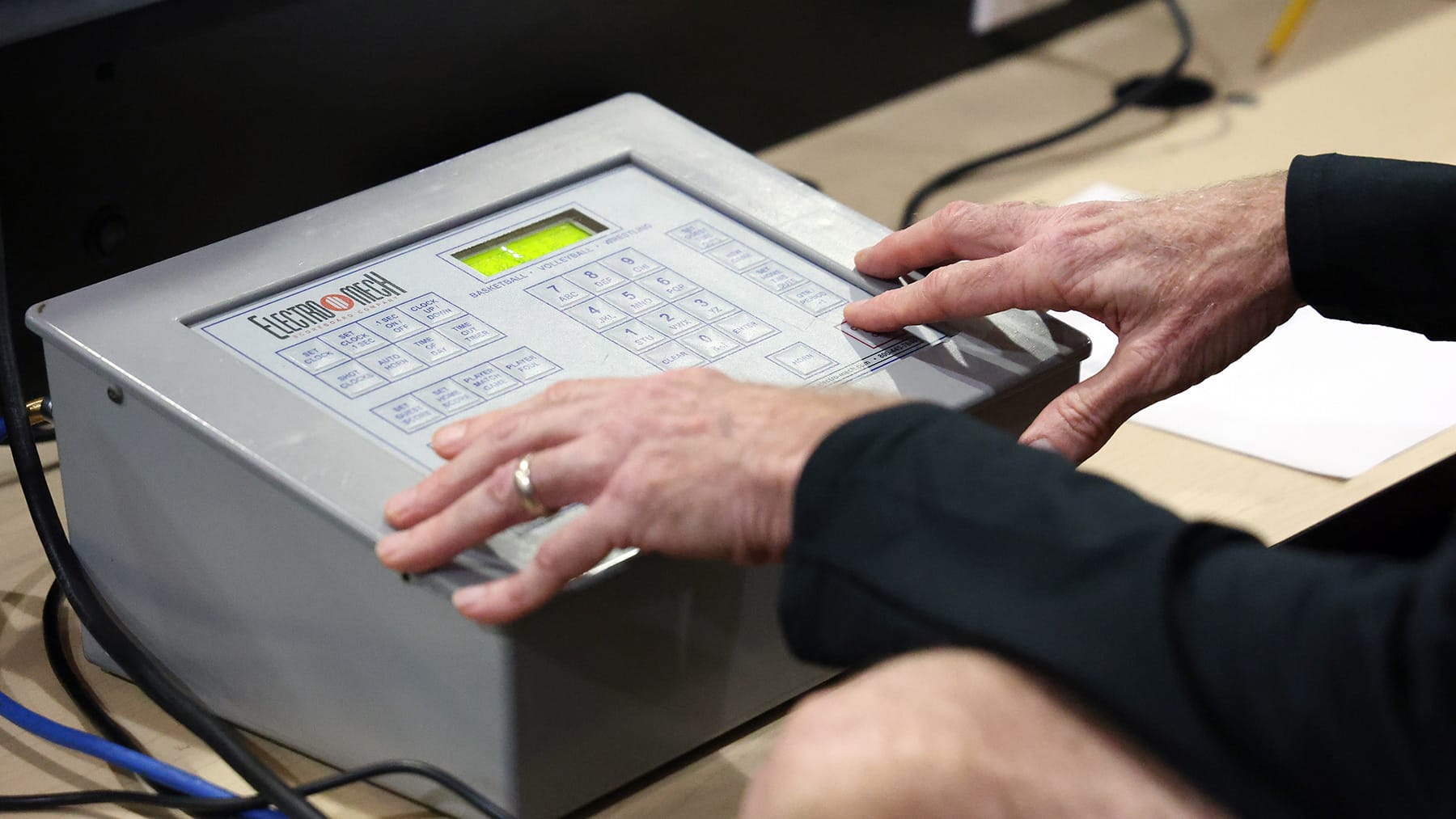 John Wilson updates the scoreboard as Gainesville High School faces Columbia High School in the school’s gymnasium Dec. 2, 2025.
