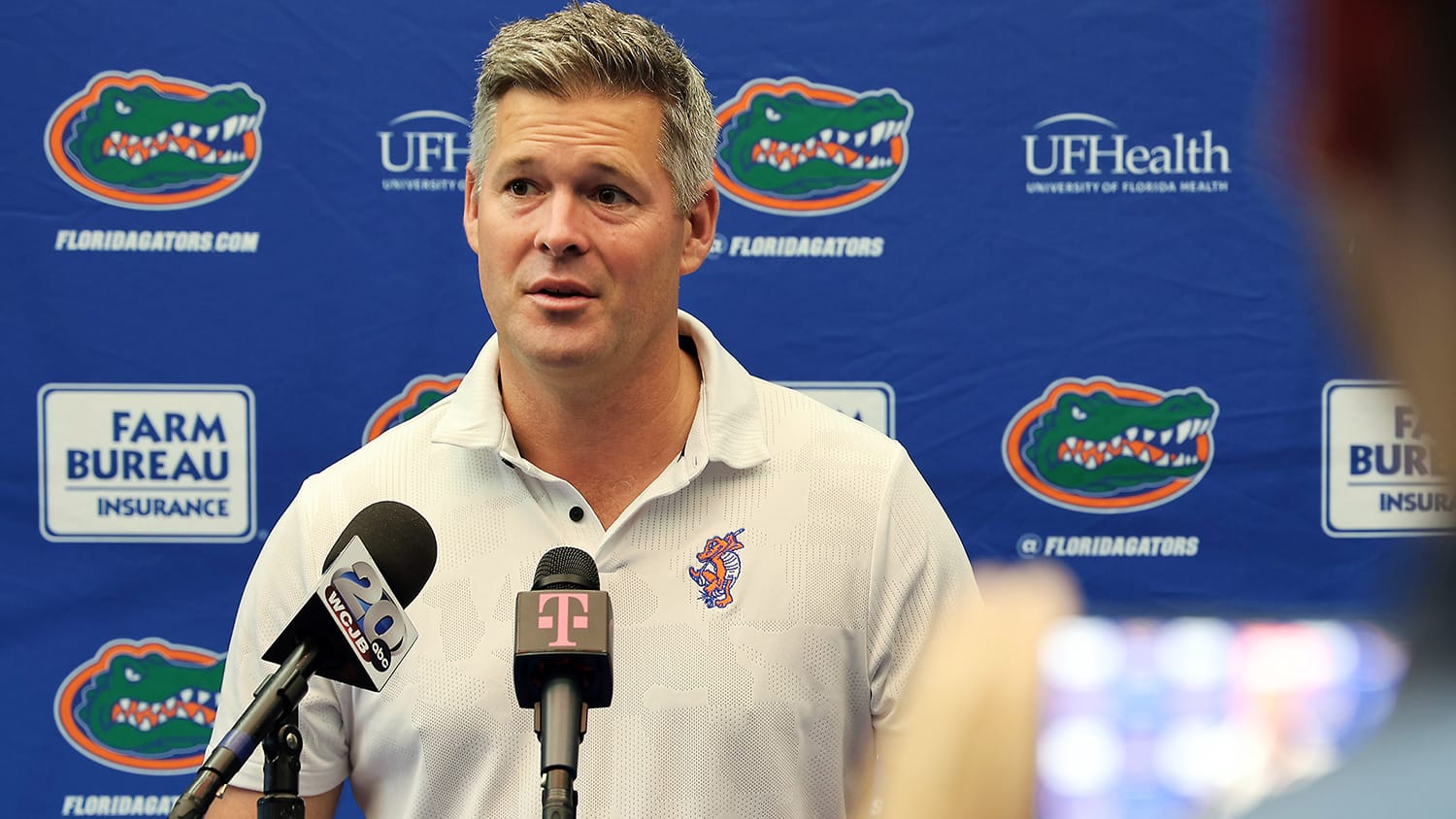 Florida golf coach J.C. Deacon speaks to the media in Gainesville, Florida.
