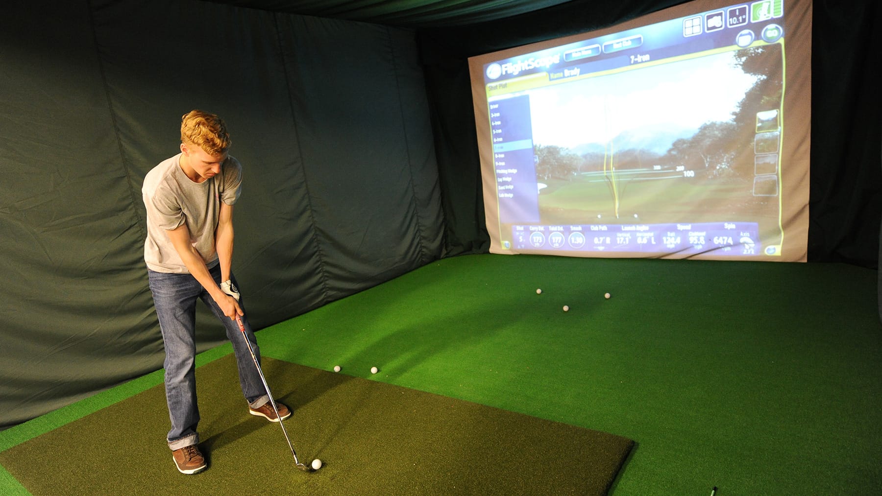 A St. Lawrence University men's golfer trains inside the St. Lawrence University Indoor Golf Center in Canton, New York, during the winter in 2025.