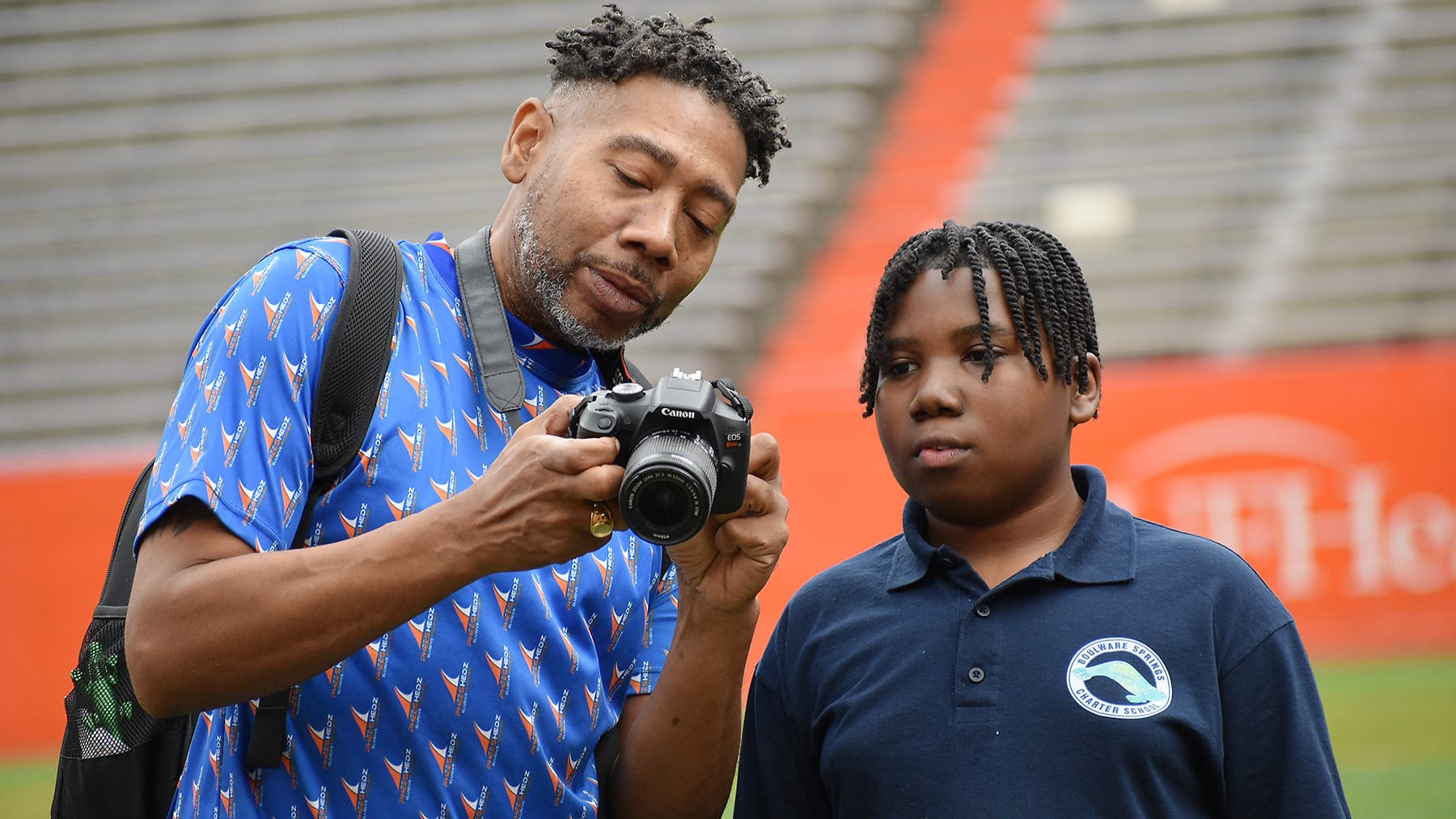Corey Williams shows his camera to his son, Cameron, while at Ben Hill Griffin Stadium in November 2025.