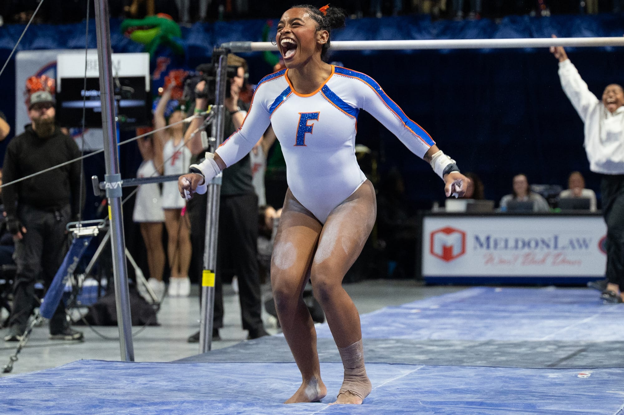 Florida gymnast Selena Harris-Miranda salutes and celebrates after sticking her landing during an NCAA gymnastics meet against Alabama in Gainesville, Fla., Friday, Jan. 16, 2026.