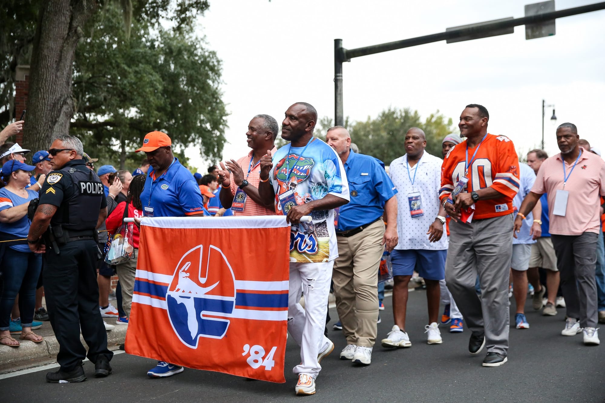 A band of players from the 1984 Florida football team that won the SEC championship walk in Gainesville before a football game against Kentucky on Oct. 19, 2024 in Ben Hill Griffin Stadium.