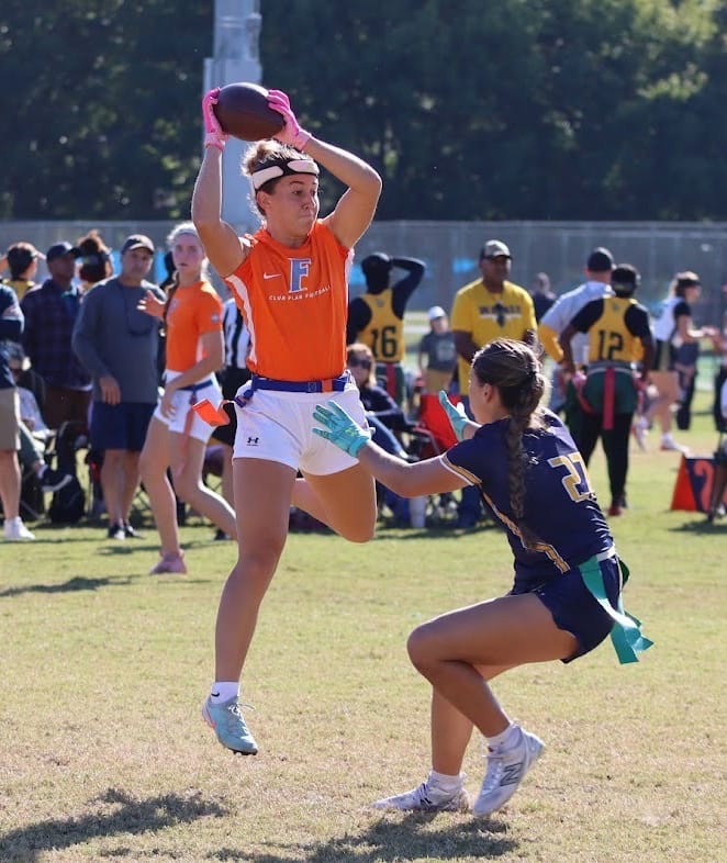 A Florida women's flag football player catches a pass during a game against Warner.
