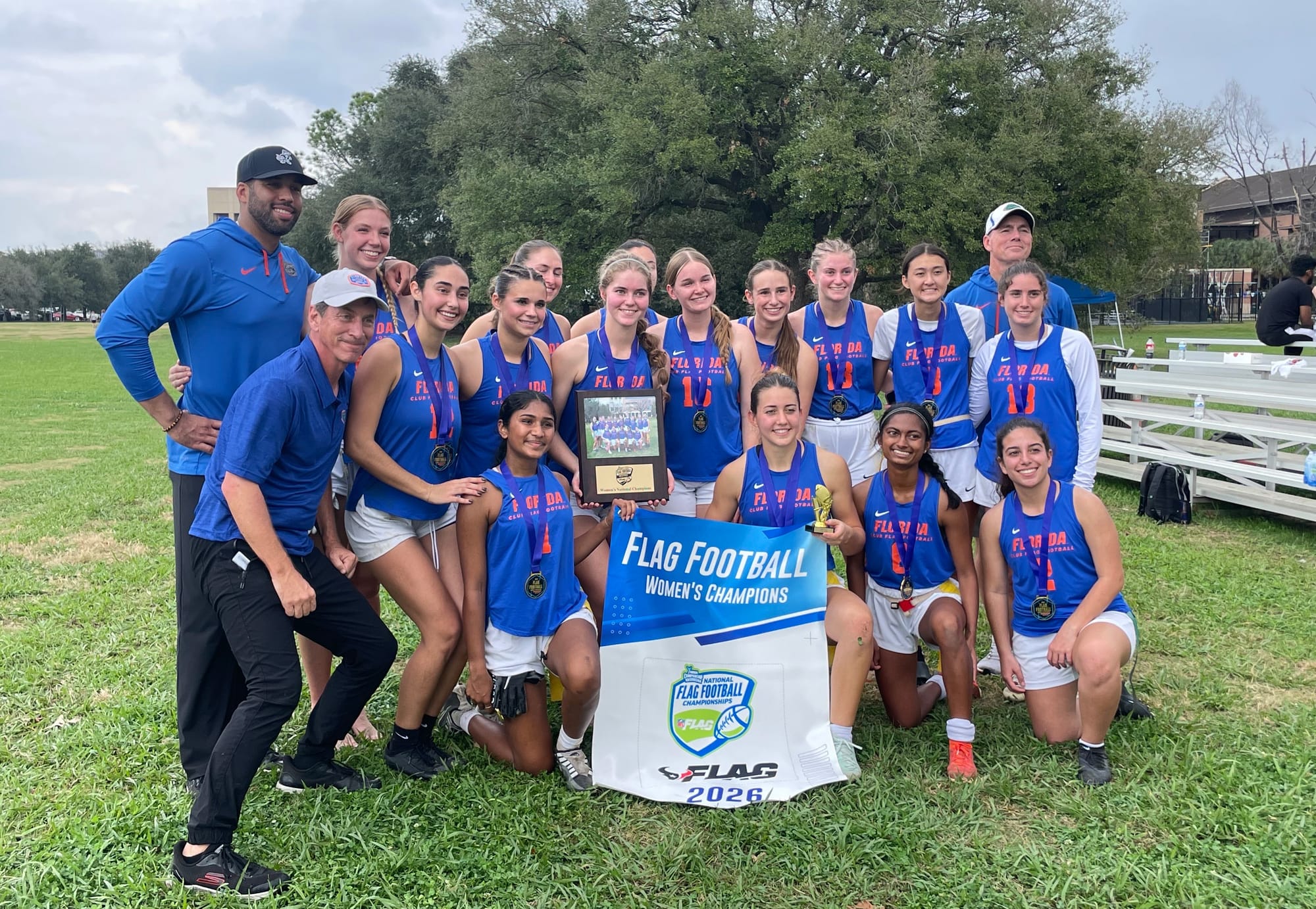 Florida's flag football team holds a championship banner from the National Intramural and Recreational Sports Association national championship in January 2026.