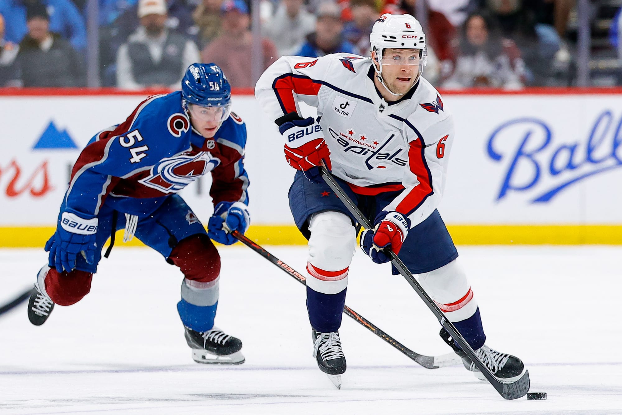  Washington Capital's Jakob Chychrun (6) skates with the puck away from Gavin Brindley (54) 