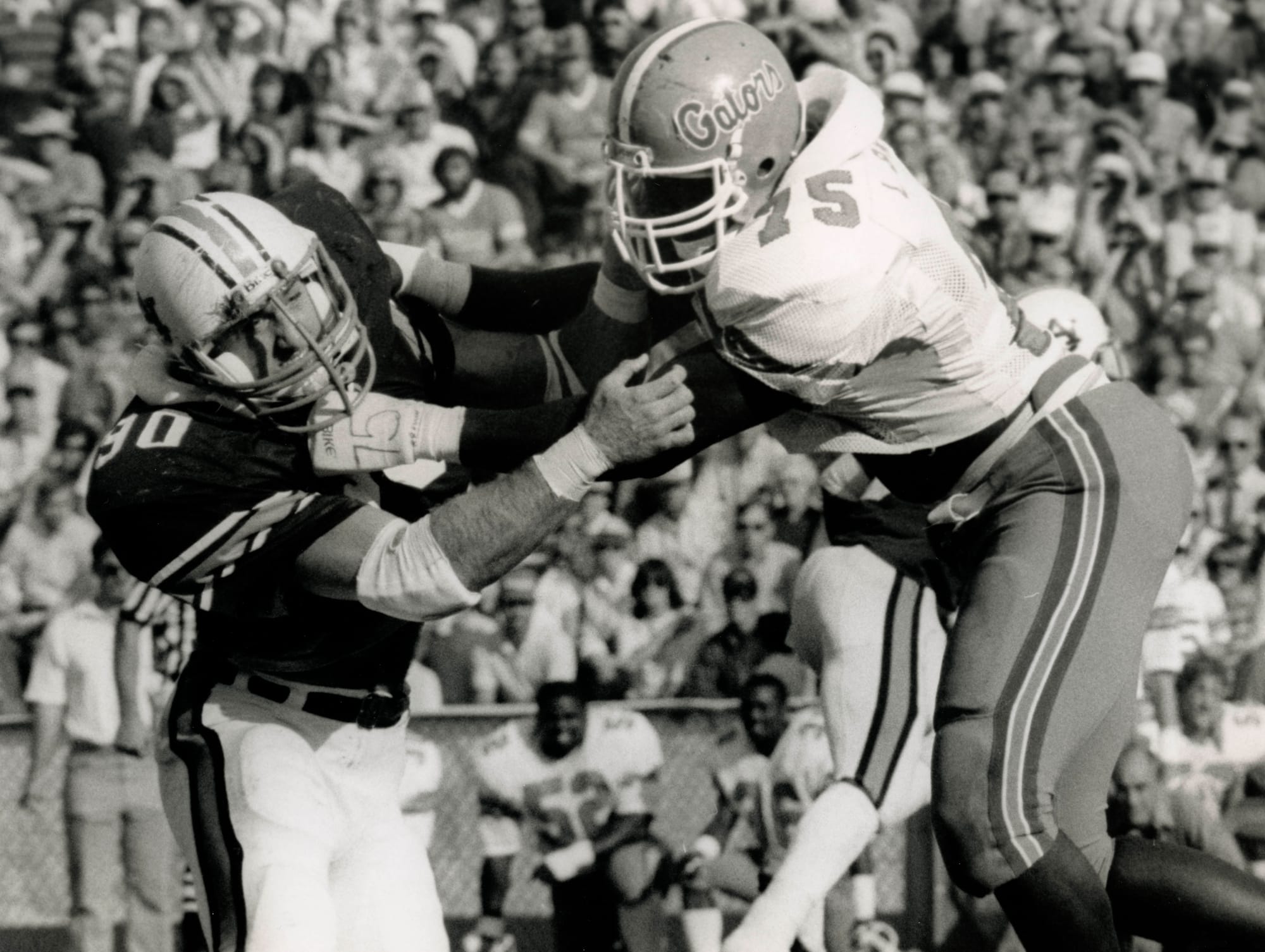 Oct 1, 1984; Unknown location, USA,FILE PHOTO; Auburn tigers defensive tackle Kevin Greene (90) in action against the Florida Gators tackle Lomas Brown, Jr.