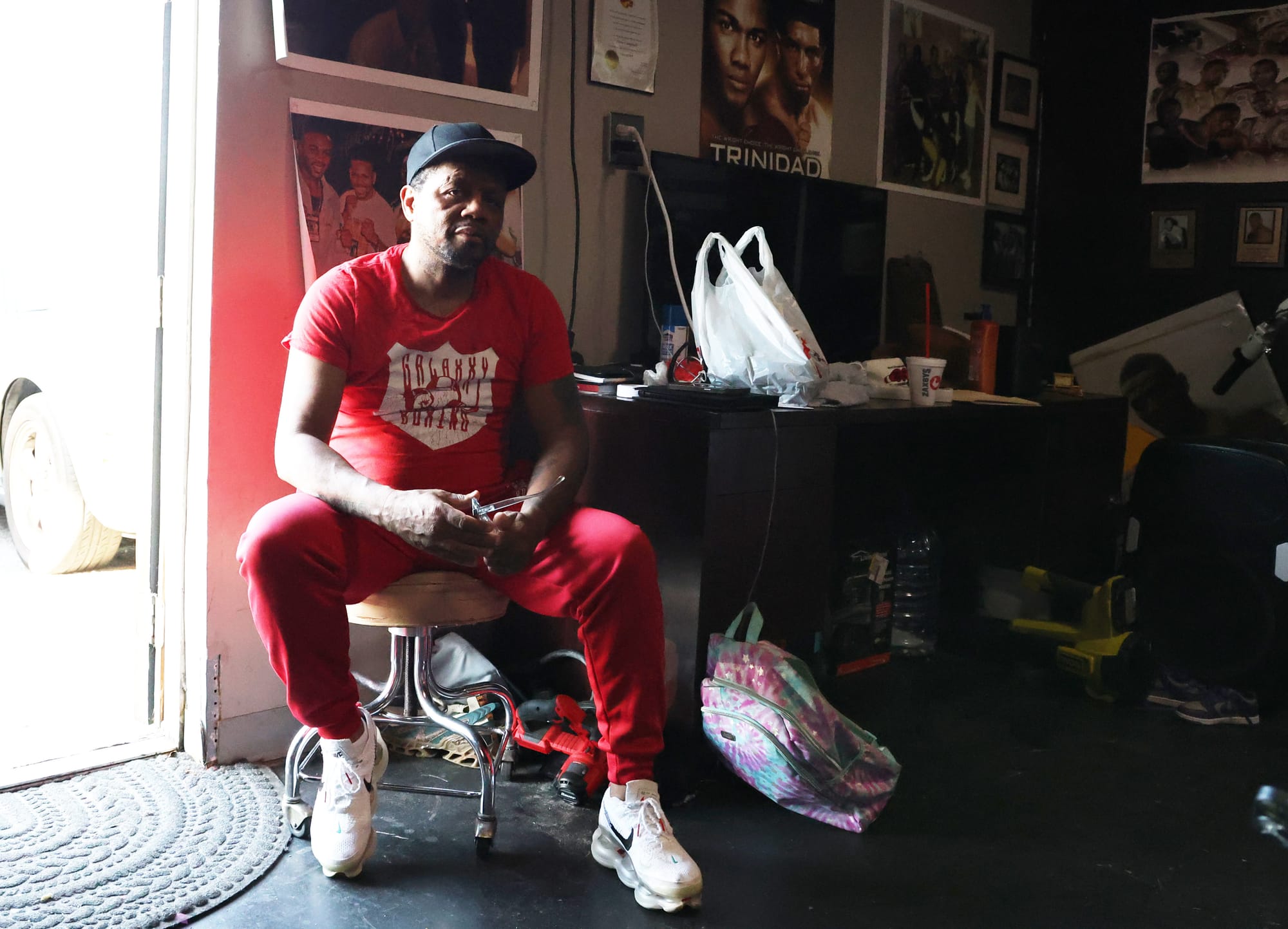 Nate Campbell sits on a stool at the front of his Galaxxy Boxing Refuge in Jacksonville on Thursday, April 23.
