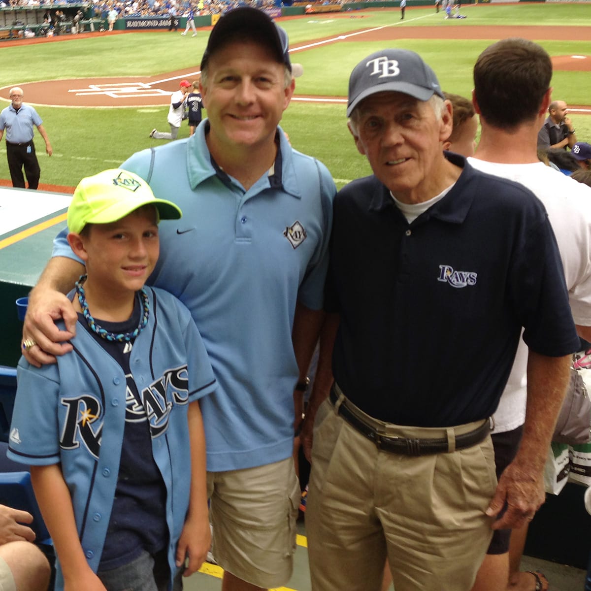 Ken Hagan poses with his father, Ken Hagan Sr., and son, Jake Hagan, before a Tampa Bay Rays game during the 2000s.