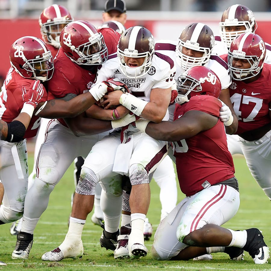 Nov 15, 2014; Tuscaloosa, AL, USA; Alabama Crimson Tide defensive lineman Jarran Reed (90), Dalvin Tomlinson (54), Xzavier Dickson (47) and Landon Collins (26) combine to stop Mississippi State Bulldogs quarterback Dak Prescott (15) in the second quarter at Bryant-Denny Stadium.