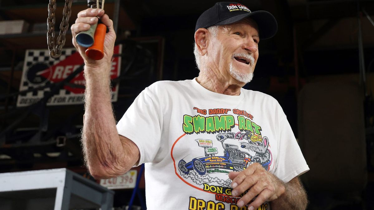 Don Garlits smiles while holding to bell-shaped objects in his hand. His shirt reads, in part, "Big Daddy" Garlits Swamp Rat on Monday, Sept. 15, 2025.