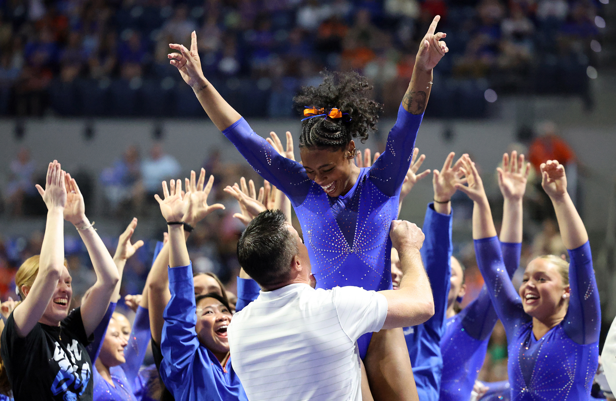 Selena Harris-Miranda celebrates as her coach tosses her  into the air after her vault performance during Florida's gymnastics meet against LSU on Sunday, March 8, 2026, in Gainesville, Fla.