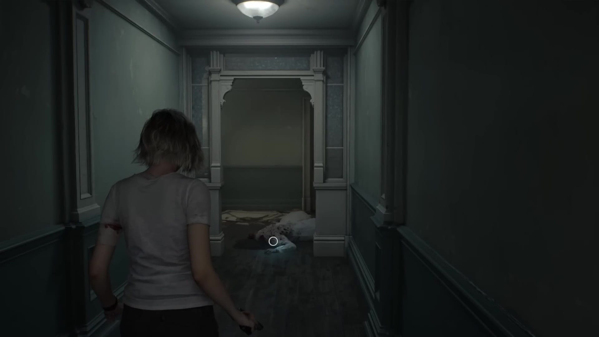 Grace walks down a hallway towards a body on the floor