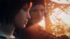 Chloe Price looks at Max Caulfield in a close-up. The sun streams through trees behind them.