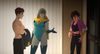 Robert (left), a thin white guy, removes his shirt. Blonde Blazer (center), a blonde woman in a mask and leotard, shrugs. Invisigal (right), a dark-haired woman in dark colors, looks mad