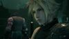 Cloud faces the viewer in close-up. Barret stands in the background, facing away from Cloud and from the viewer.