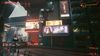 A street in Cyberpunk 2077 overshadowed by several neon billboards, including a version of the 'Mix It Up' advertisement.