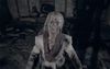 Eveline sits in a chair, tortured, with blood pouring out of her eyes.