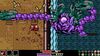 Mina wields a hammer over her head while battling a massive purple sea monster, whose limbs are smashing onto the ship deck where Mina stands.
