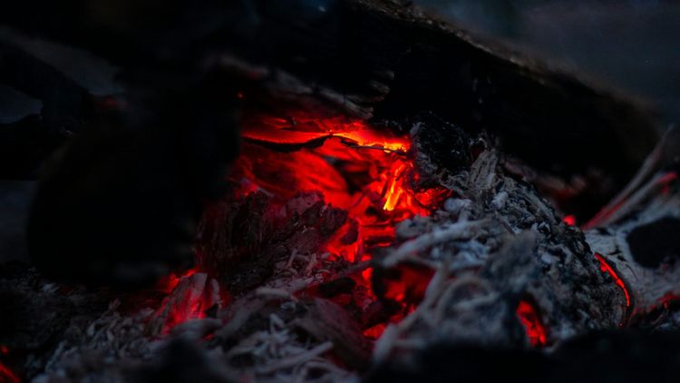 glowing embers in a pan or pot of some kind