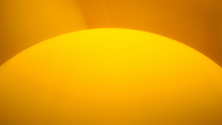 mostly yellow image of what might be the top portion of the sun