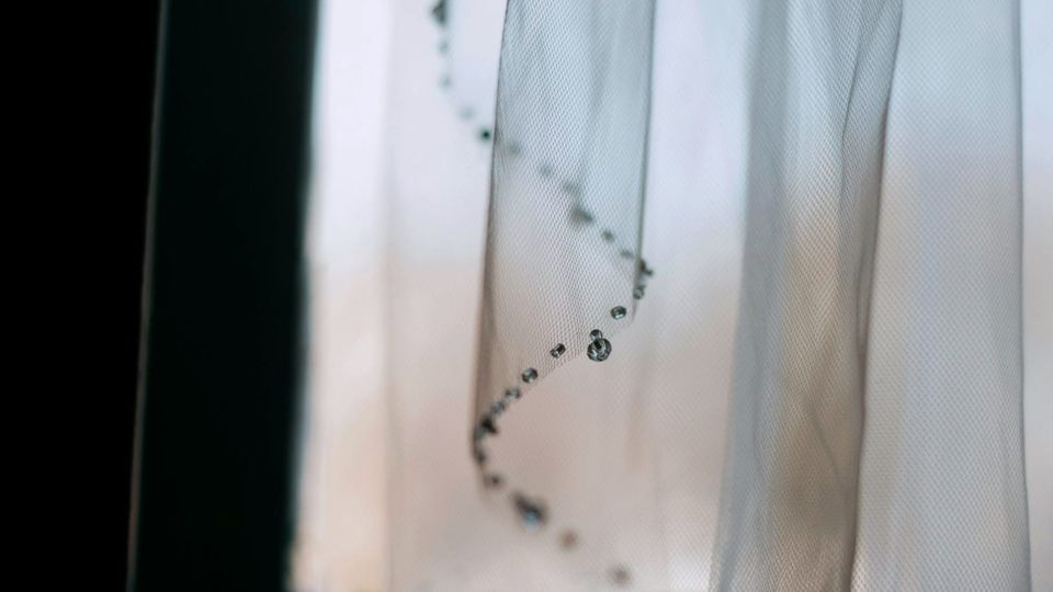 a very thin veil or curtain with a window behind it