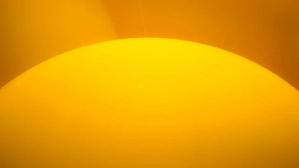 mostly yellow image of what might be the top portion of the sun