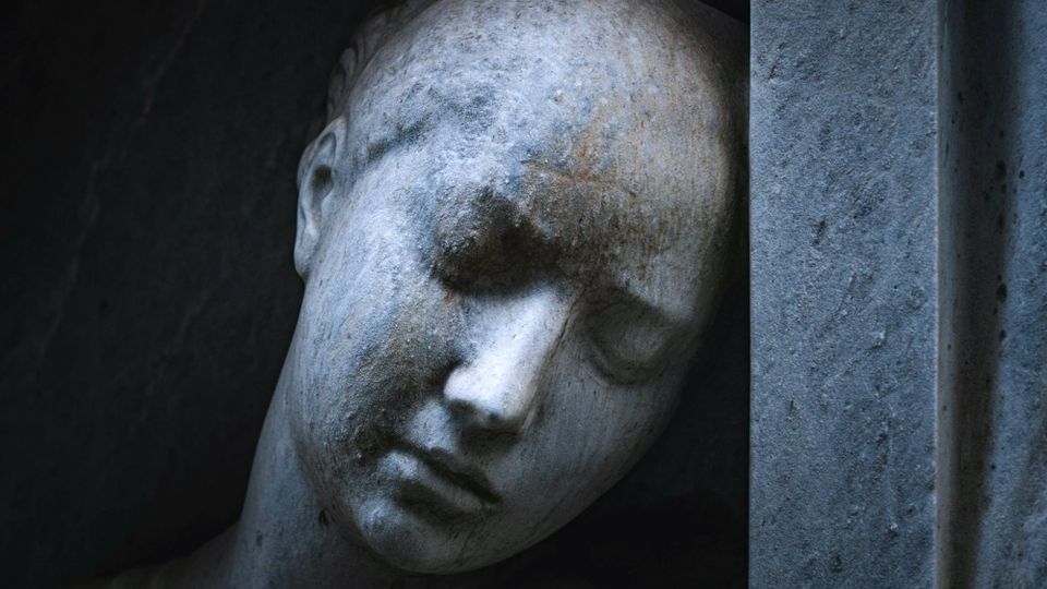 close-up view of a melancholy female face on a sculpture