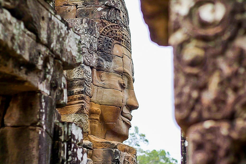Giant stone carved smiling faces at Bayon Temple in the Angkor Thom complex, Cambodia