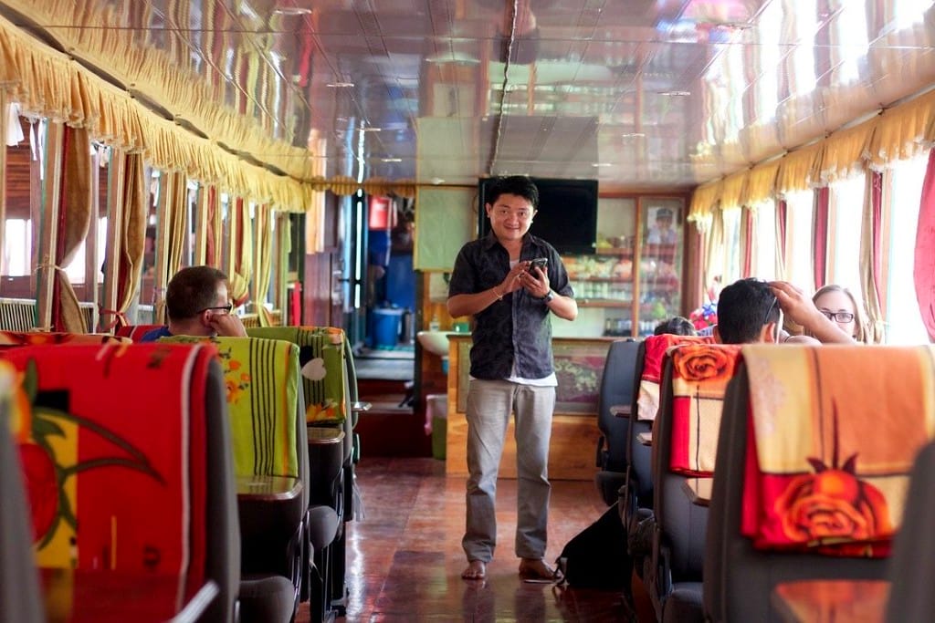 Tour guide Kat giving instructions to passengers on the Mekong River slow boat