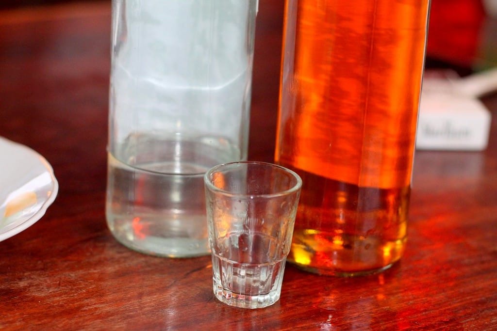 Local Lao whisky shots served after dinner at the riverside lodge