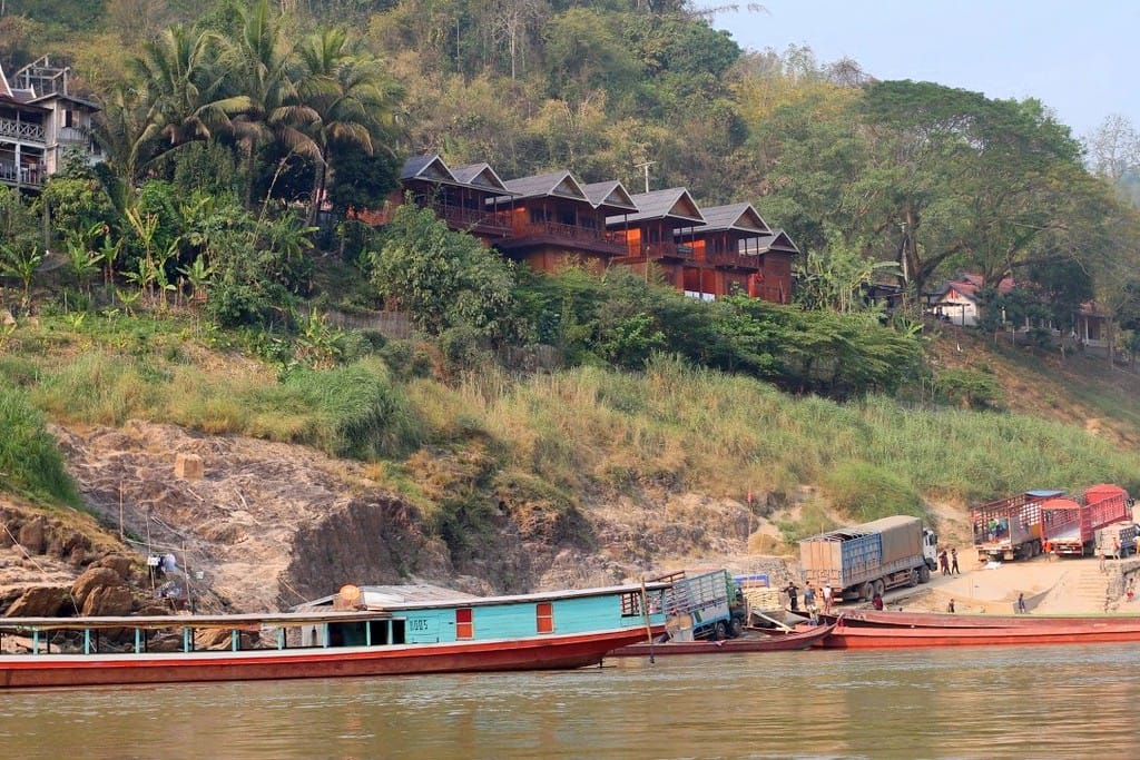 Mekong Riverside Lodge with traditional wooden bungalows viewed from the river