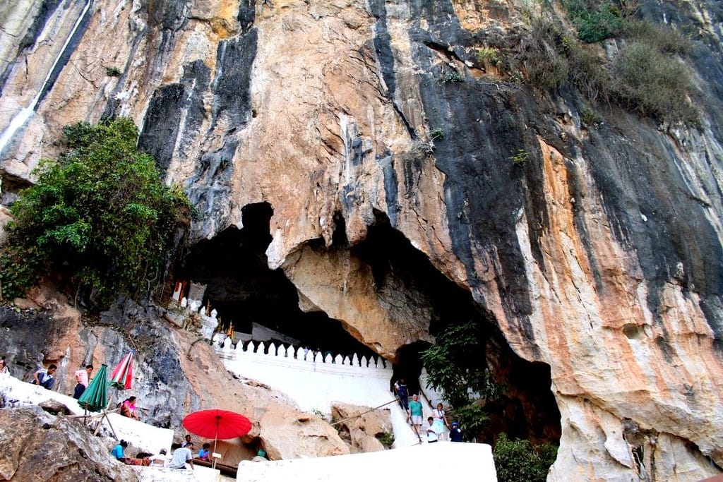 Entrance to the Pak Ou Caves with Buddha statues overlooking the Mekong River