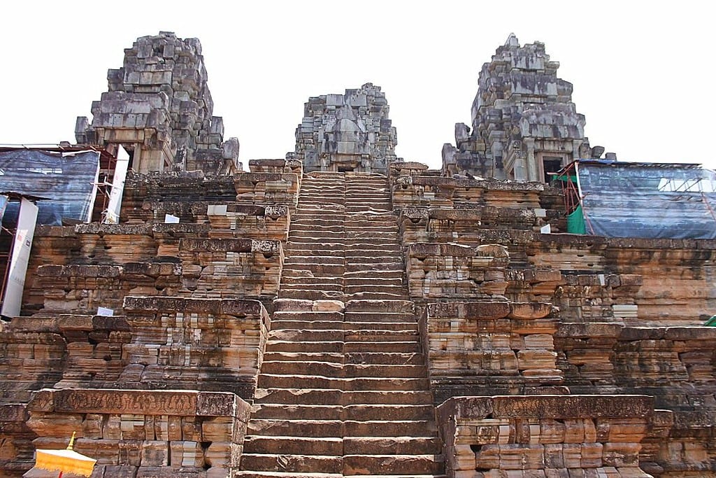 The imposing unfinished pyramid of Ta Keo temple rising above the jungle at Angkor, Cambodia