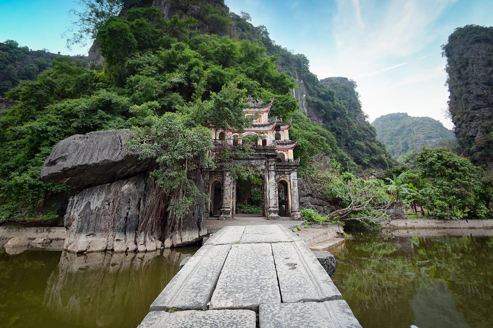 Bich Dong Pagoda nestled in lush green karst landscape in Tam Coc, Vietnam