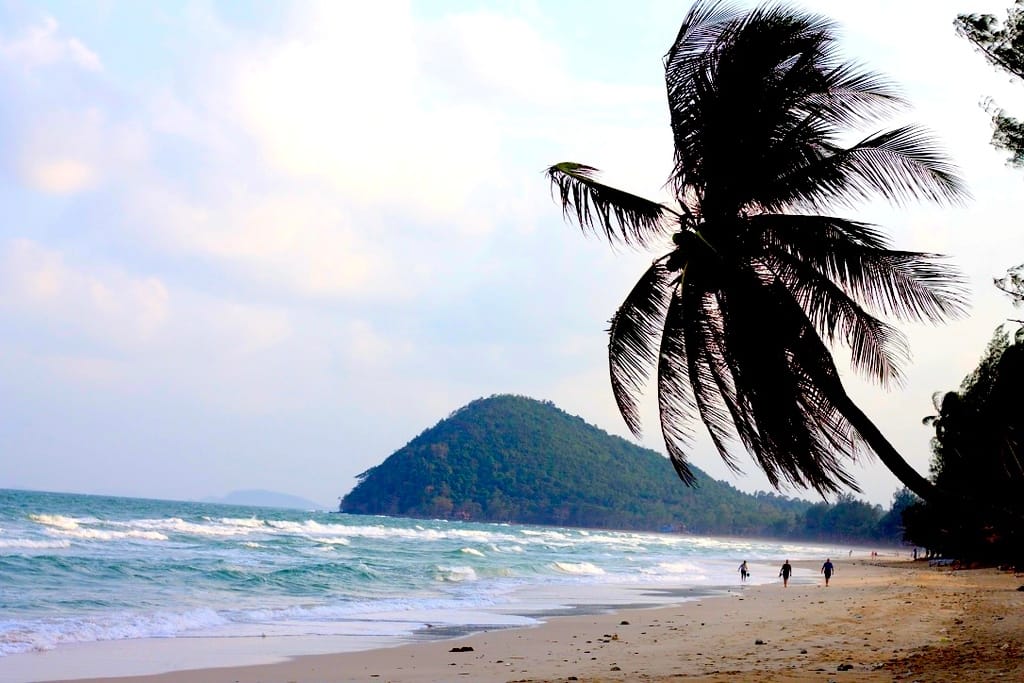White sand beach at Thung Wua Laen with turquoise water and palm trees in Thailand