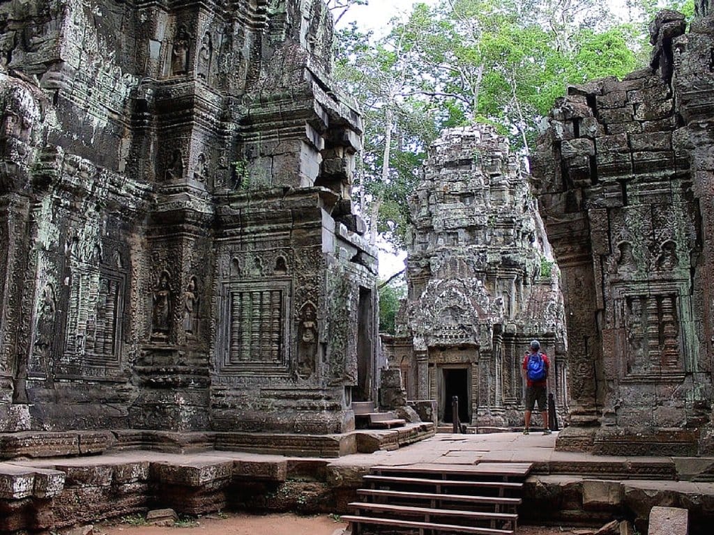 Ta Prohm temple with tree roots growing over ancient stone walls, filming location of Tomb Raider in Angkor, Cambodia